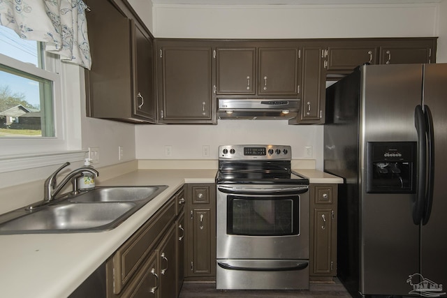 kitchen featuring light countertops, stainless steel appliances, a sink, and exhaust hood