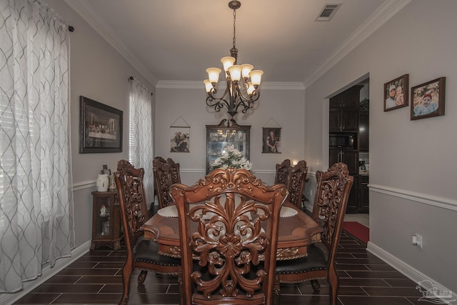 dining area featuring ornamental molding and an inviting chandelier