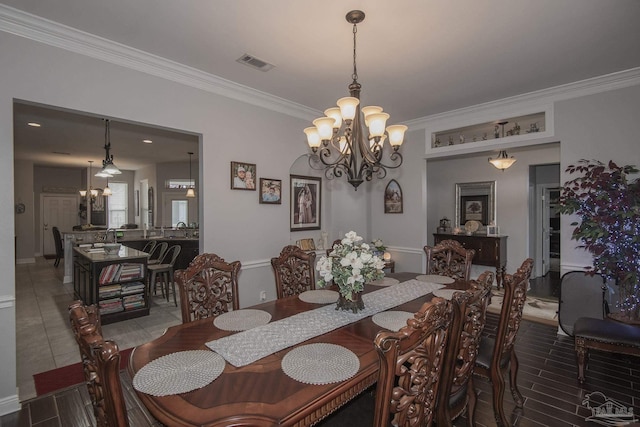 dining area featuring ornamental molding and a chandelier