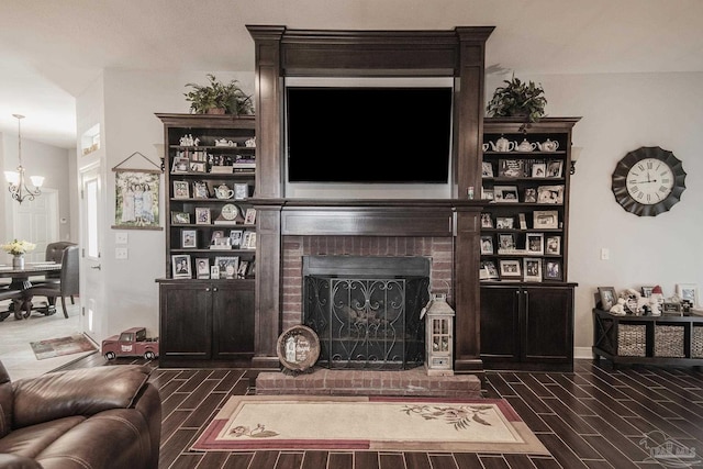 living room with a fireplace and an inviting chandelier