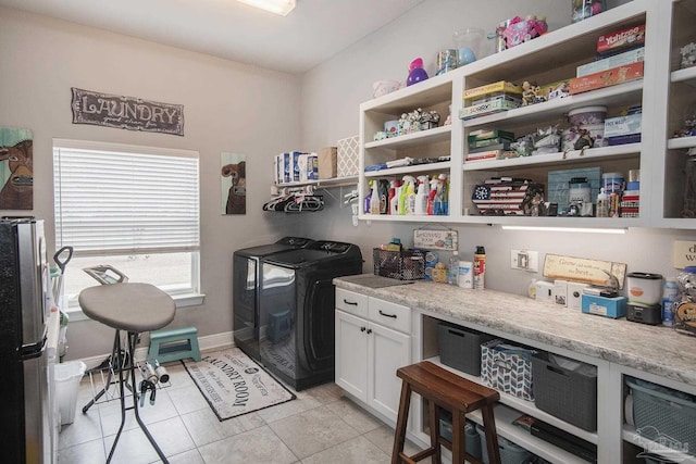 laundry room with washing machine and dryer and light tile patterned flooring