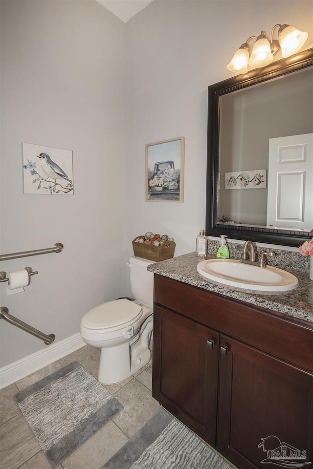 bathroom featuring vanity, tile patterned floors, and toilet