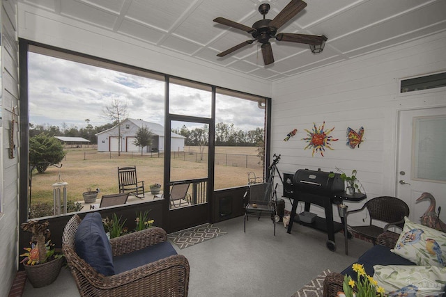 sunroom / solarium featuring ceiling fan