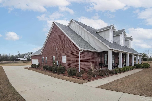 view of property exterior with a garage and a porch