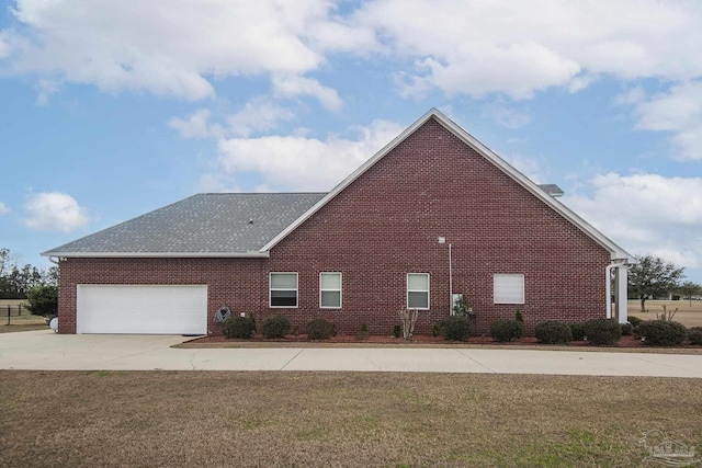 view of side of home with a garage and a yard