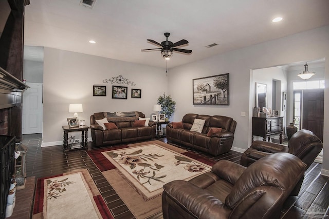 living room with ceiling fan and dark hardwood / wood-style flooring