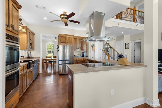 kitchen featuring island exhaust hood, stainless steel appliances, a kitchen island, and ceiling fan