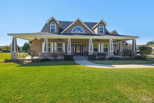 view of front of property with ceiling fan, a front yard, and a porch