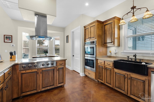 kitchen with appliances with stainless steel finishes, sink, plenty of natural light, and island range hood