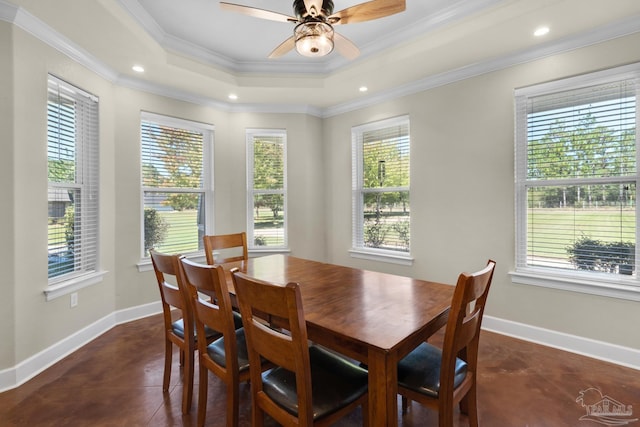 dining area featuring a healthy amount of sunlight, ornamental molding, and dark tile patterned floors