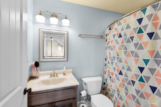 bathroom with vanity, toilet, and curtained shower