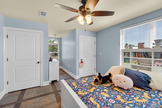 bedroom featuring ceiling fan and multiple windows