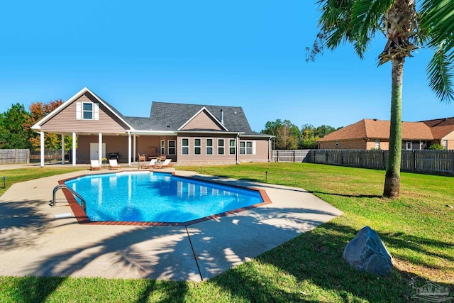 view of swimming pool featuring a yard and a patio