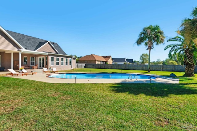 view of swimming pool with a patio and a yard