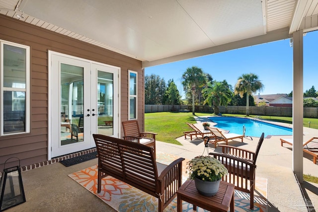 view of patio / terrace featuring french doors and a fenced in pool