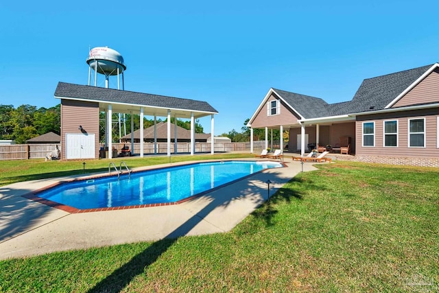 view of pool featuring a patio and a lawn