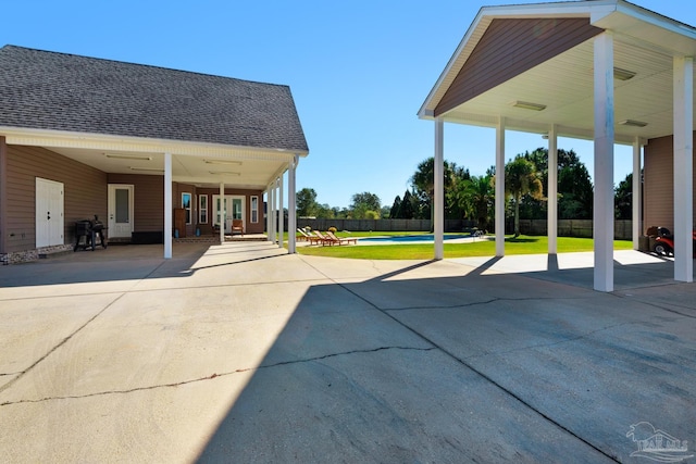 view of patio / terrace featuring a carport and a pool