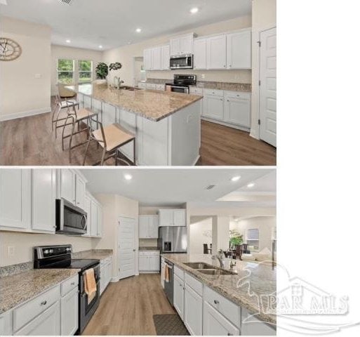 kitchen with a kitchen bar, a large island, white cabinets, and appliances with stainless steel finishes