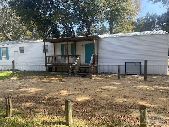 view of front of home featuring a porch and metal roof