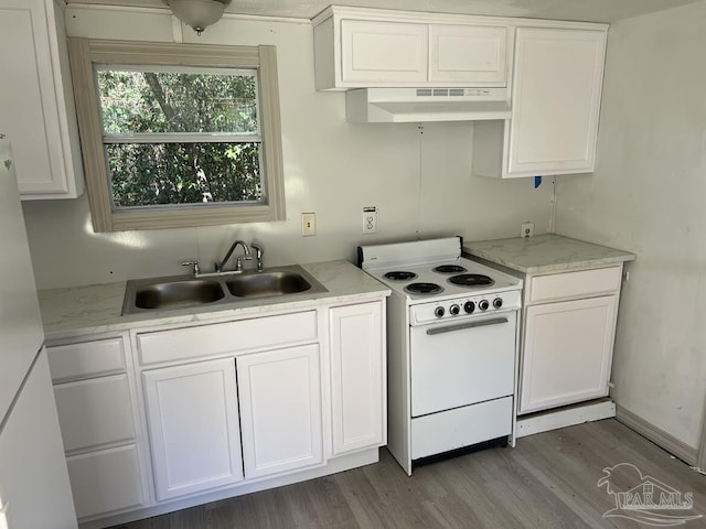 kitchen with white appliances, white cabinetry, a sink, and under cabinet range hood