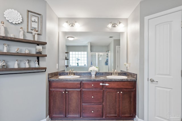 6018 Autumn Pines Cir, Pace, FL 32571 - bathroom featuring baseboards, double vanity, a stall shower, and a sink