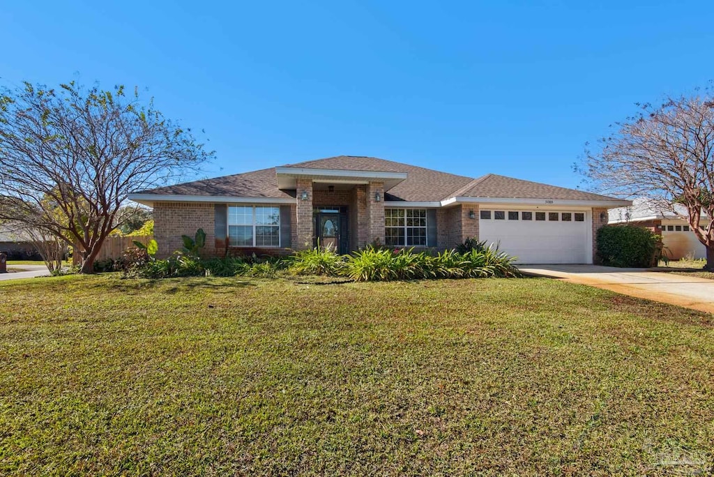 view of front of house with a garage and a front yard