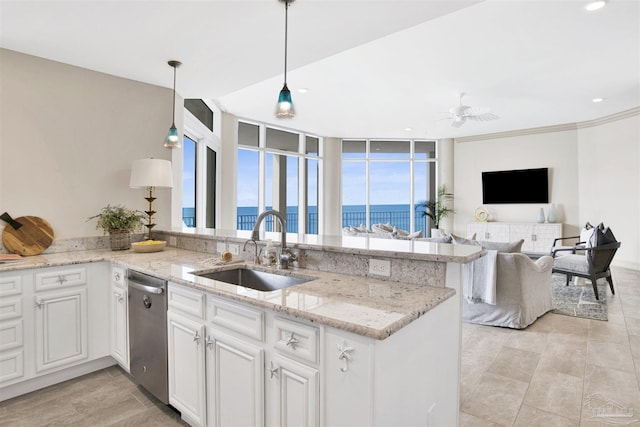 kitchen with sink, white cabinetry, light stone countertops, decorative light fixtures, and stainless steel dishwasher