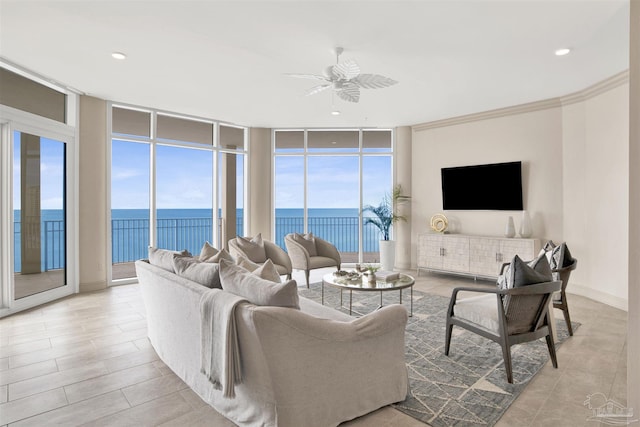 living room with ceiling fan, crown molding, and a wall of windows