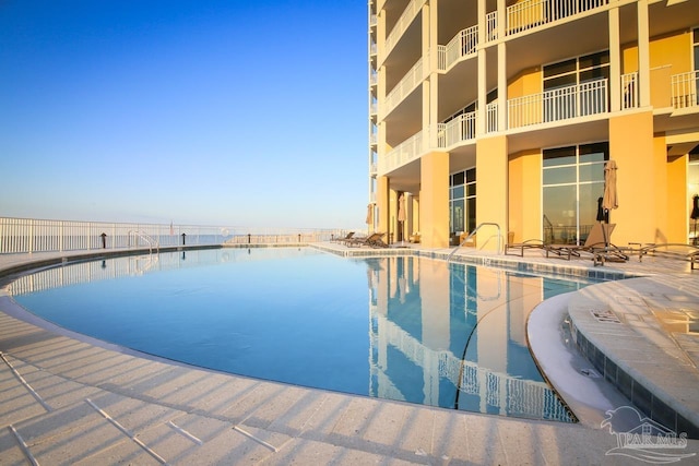 view of swimming pool featuring a water view