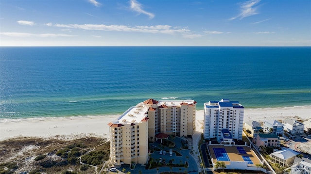 drone / aerial view featuring a beach view and a water view