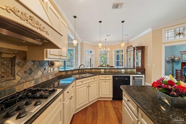 kitchen featuring black dishwasher, light hardwood / wood-style flooring, tasteful backsplash, sink, and ornamental molding