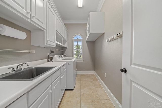 washroom featuring sink, cabinets, light tile patterned floors, separate washer and dryer, and ornamental molding