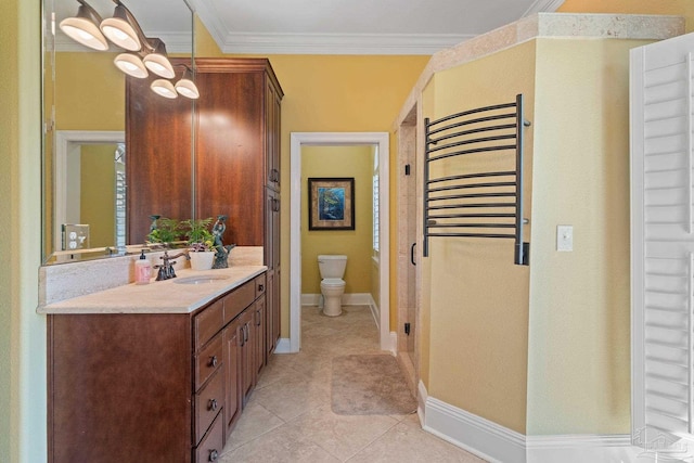 bathroom featuring vanity, tile patterned floors, crown molding, and toilet