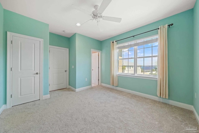 unfurnished bedroom with light carpet and ceiling fan