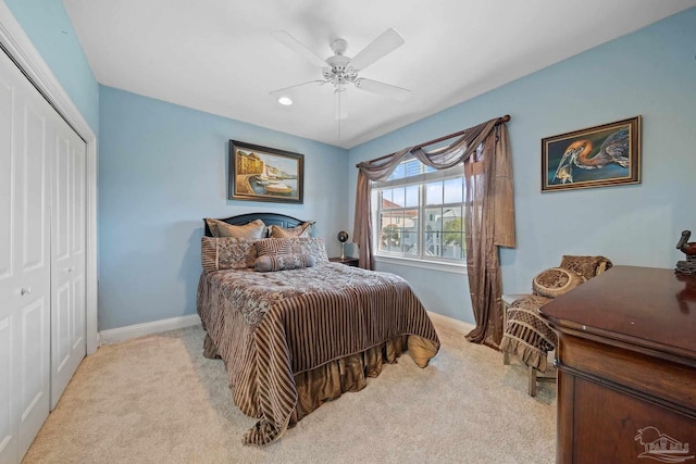 bedroom with light carpet, a closet, and ceiling fan