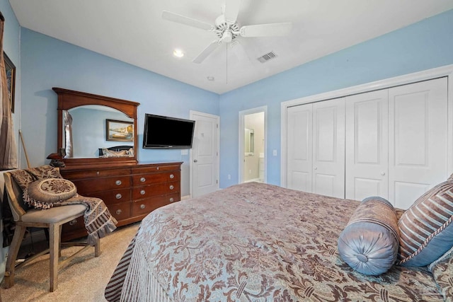 bedroom with light carpet, ceiling fan, and a closet