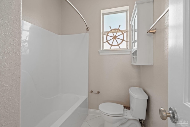 bathroom featuring toilet, tile patterned floors, and shower / bathing tub combination