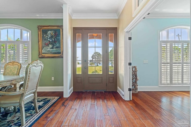 entryway with ornamental molding, a healthy amount of sunlight, and dark hardwood / wood-style floors