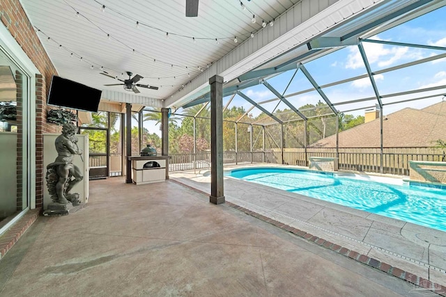 view of swimming pool with a lanai, a patio, pool water feature, and ceiling fan