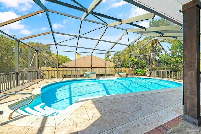 view of pool featuring a patio, pool water feature, and a lanai