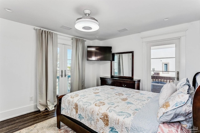 bedroom with hardwood / wood-style flooring, french doors, and access to exterior