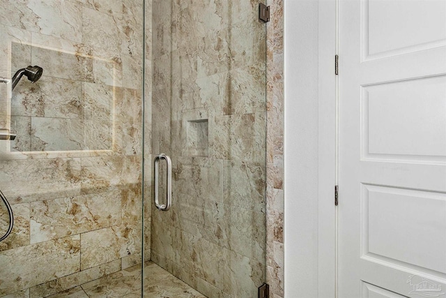 bathroom featuring a shower with shower door