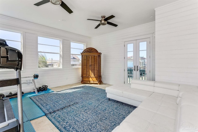 interior space featuring ornamental molding, a wealth of natural light, ceiling fan, and french doors