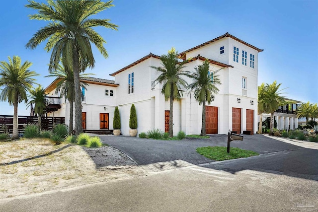 mediterranean / spanish-style home with a garage