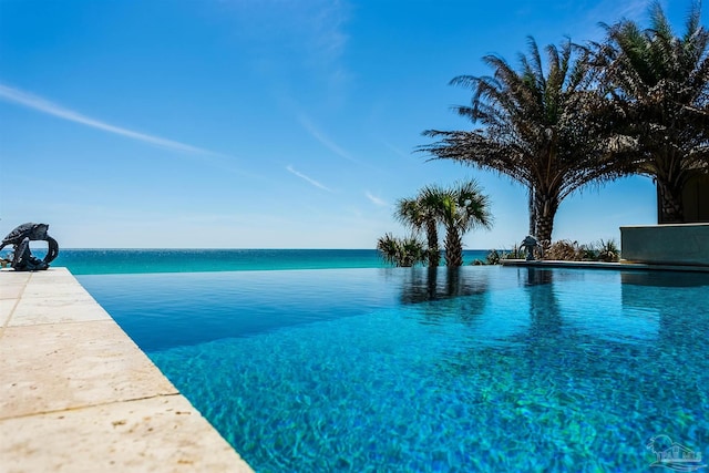 view of pool featuring a water view