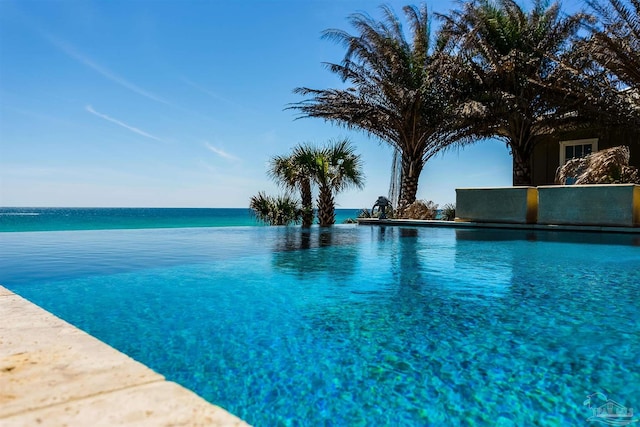 view of swimming pool featuring a water view