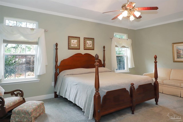 carpeted bedroom with crown molding and ceiling fan