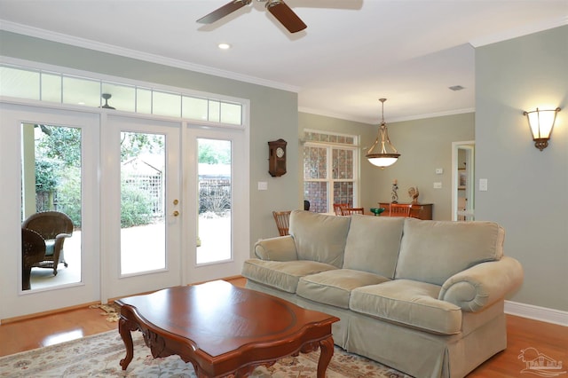 living room with light hardwood / wood-style flooring, ornamental molding, french doors, and ceiling fan