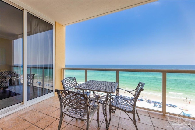 balcony with a water view and a beach view