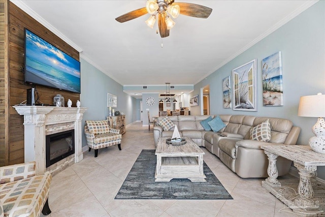 living room featuring ornamental molding, light tile patterned floors, and ceiling fan